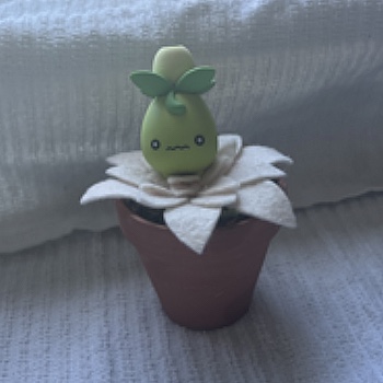 Since Smoliv is a grass type Pokemon I thought it would be a fun challenge to put him in the plant so he could have a habitat.